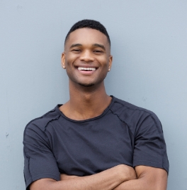 friendly black man smiling with arms crossed P7ZUNZY 2